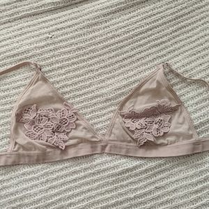 Nude bralette with floral design on it